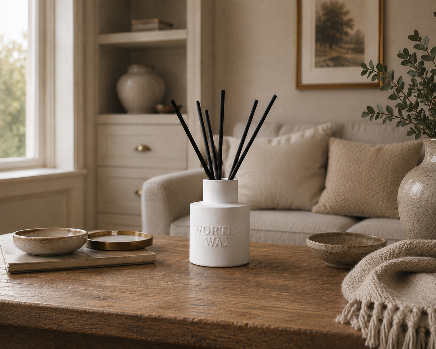Cashmere Santal reed diffuser with black reeds in a matte ceramic Worthy Wax bottle